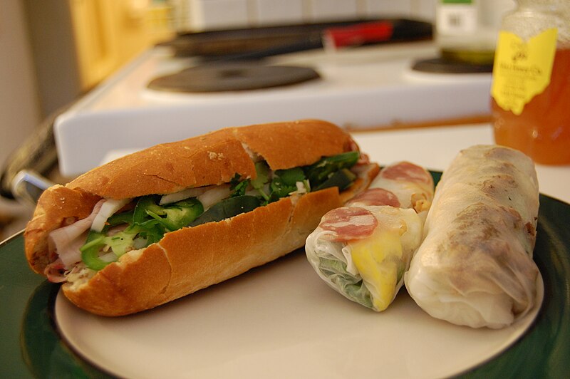 A spread of bánh mì and Vietnamese spring rolls on a tour stop