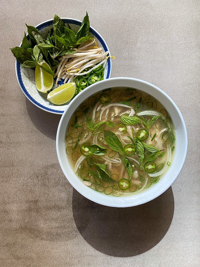 A bowl of chicken phở freshly prepared in a home kitchen — one of many Hanoi cooking experiences